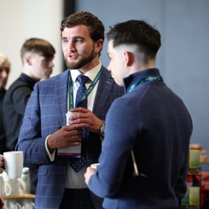 Two young people conversing at a business conference