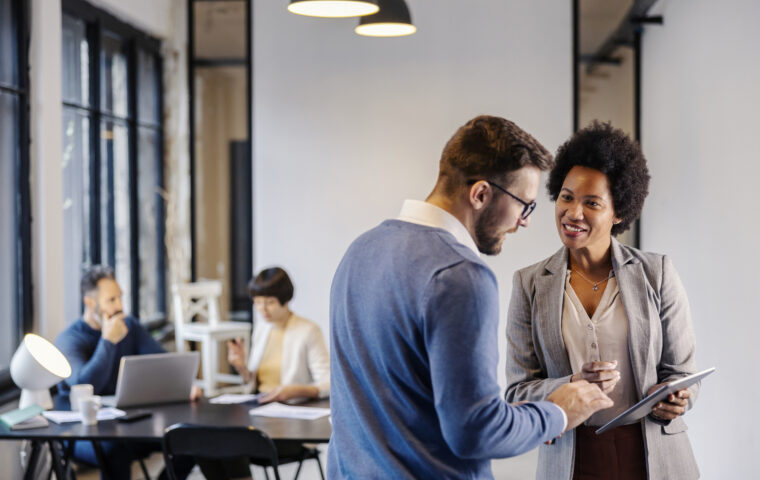 Business professional providing advice standing with a tablet