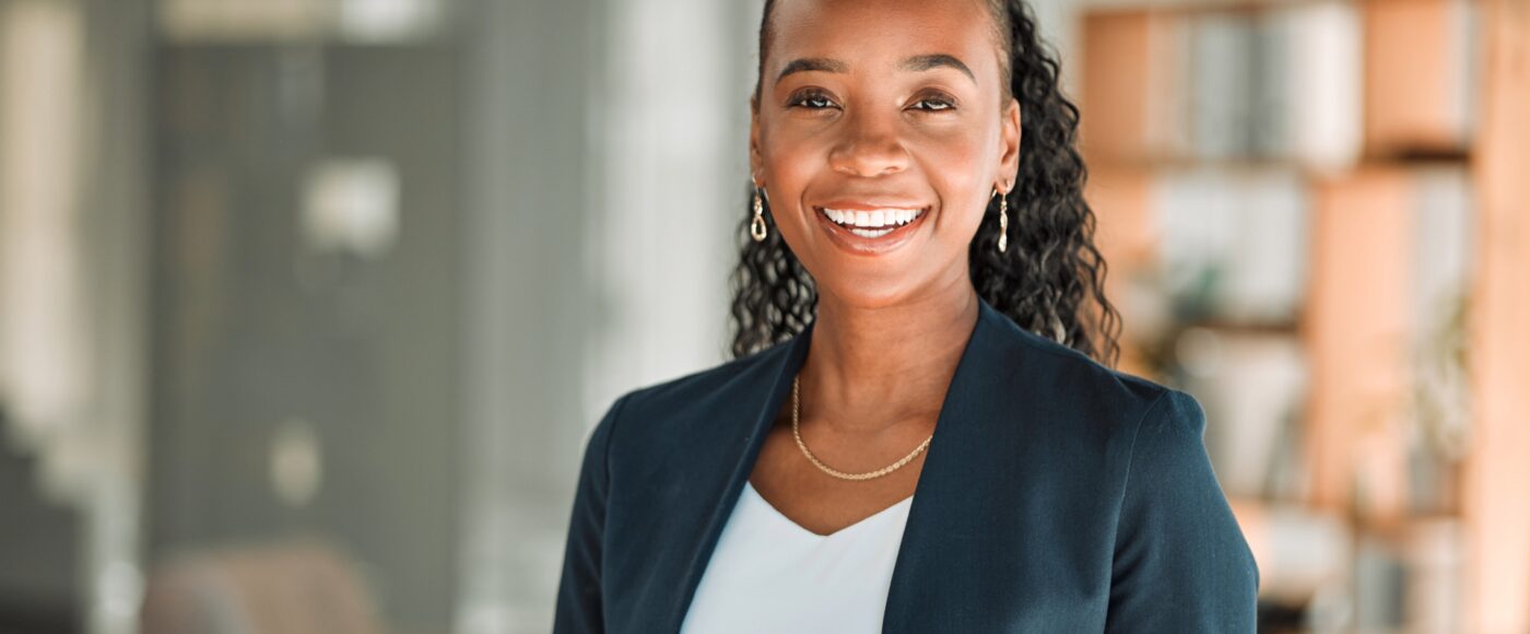 Smiling office worker with black blazer and white shirt