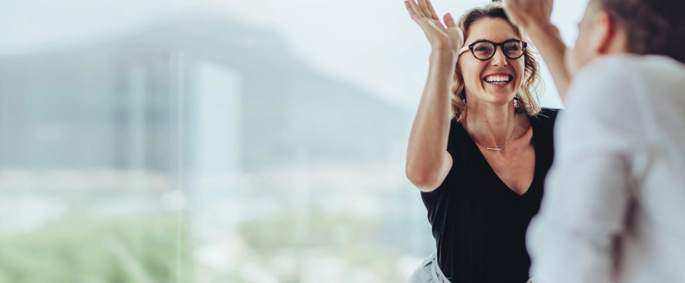 Two office workers celebrating in work