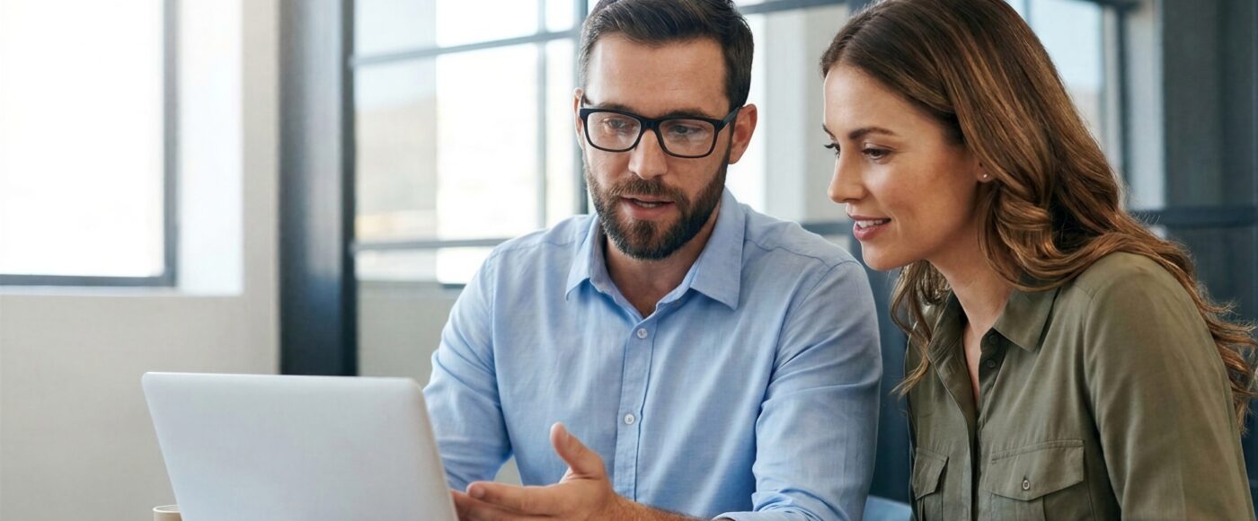 two office workers on laptop completing AI project