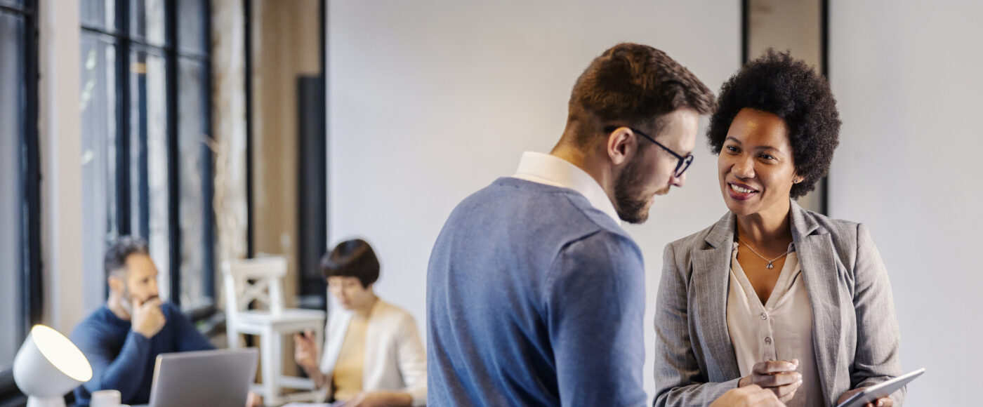 Business professional providing advice standing with a tablet