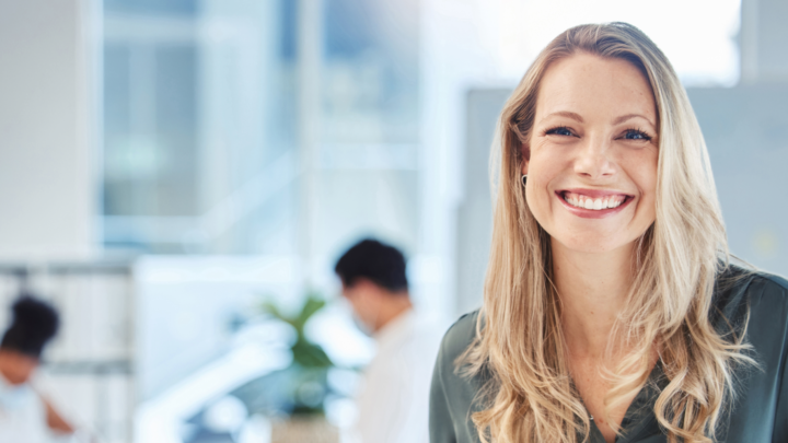 Smiling business professional in bright natural lit office