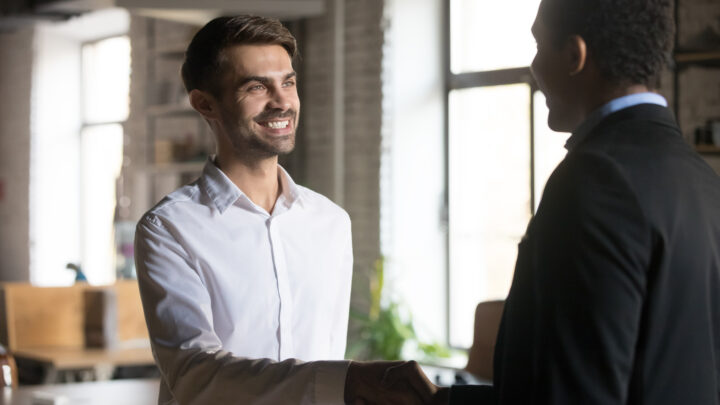 I Stock Business Angel funding business manager shaking hand of staff member