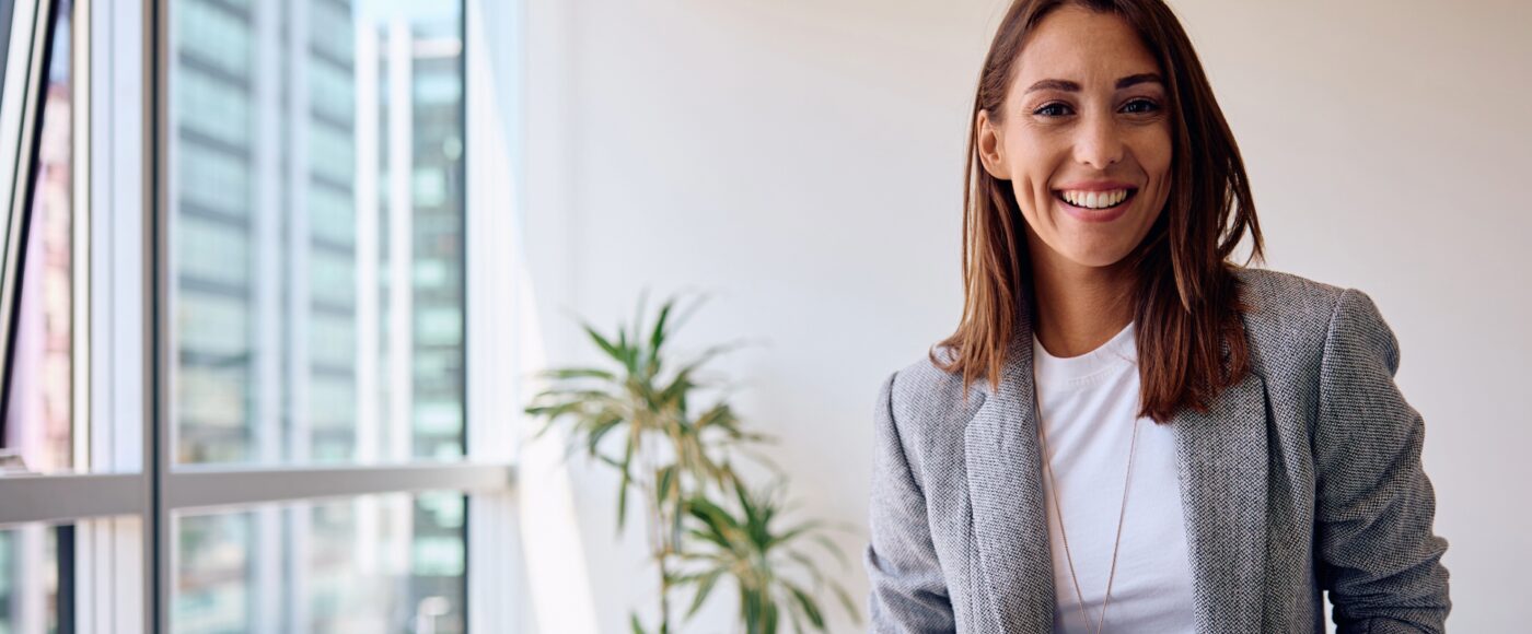 Smiling business woman in white office