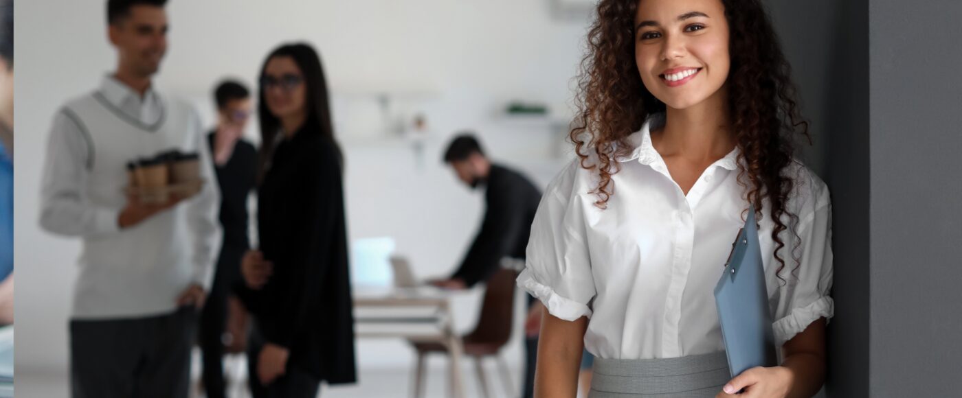 Smiling office worker holding a clipboard
