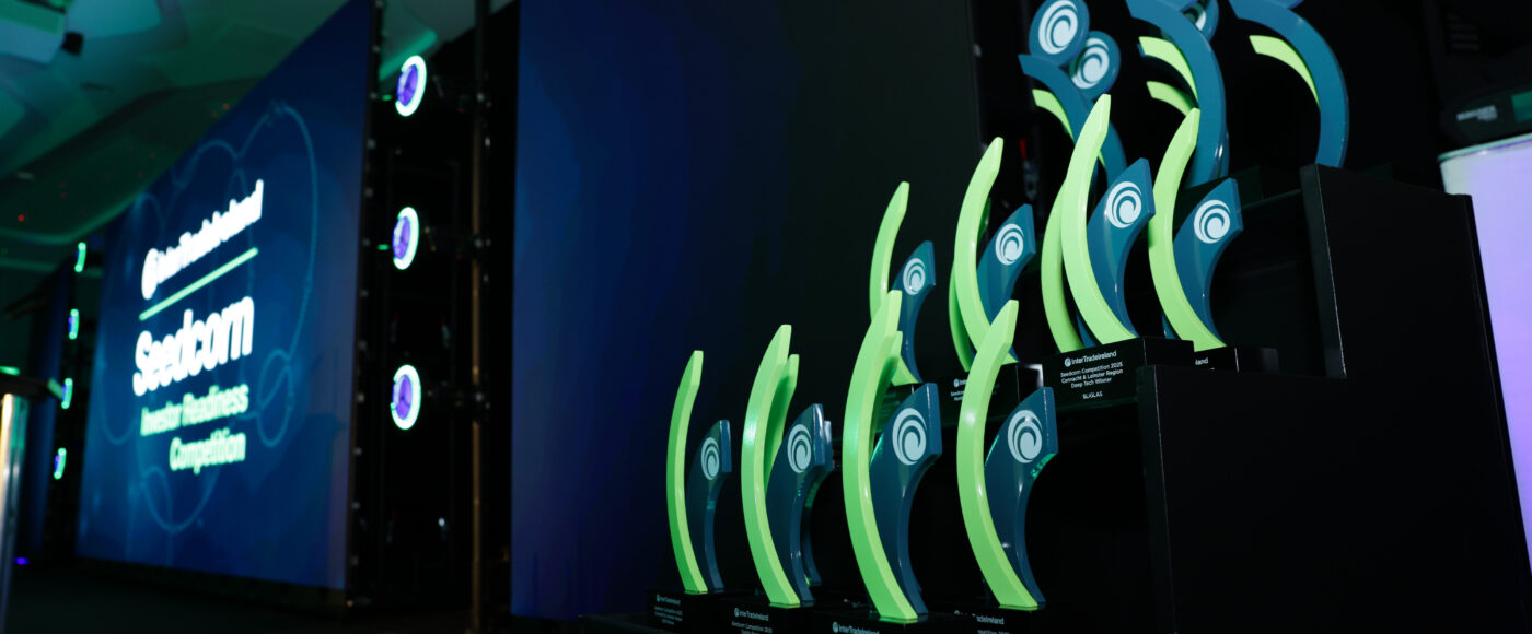Seedcorn Awards trophies displayed on stage at a previous awards ceremony.