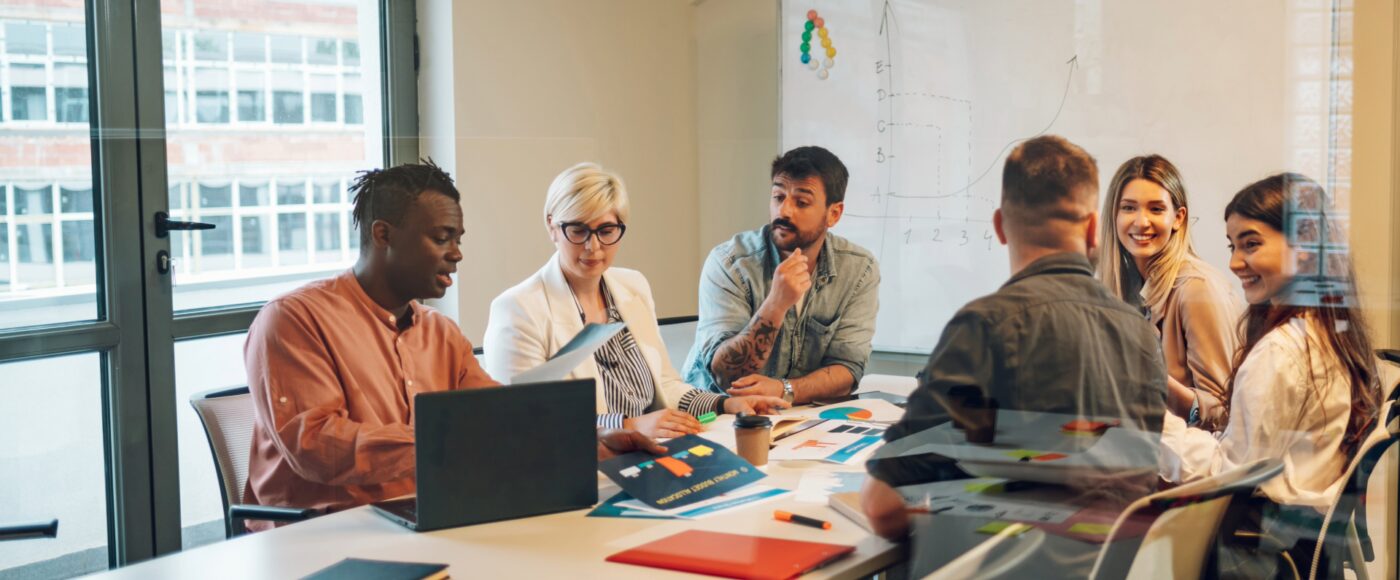 Professionals participating in a team meeting around a conference table.
