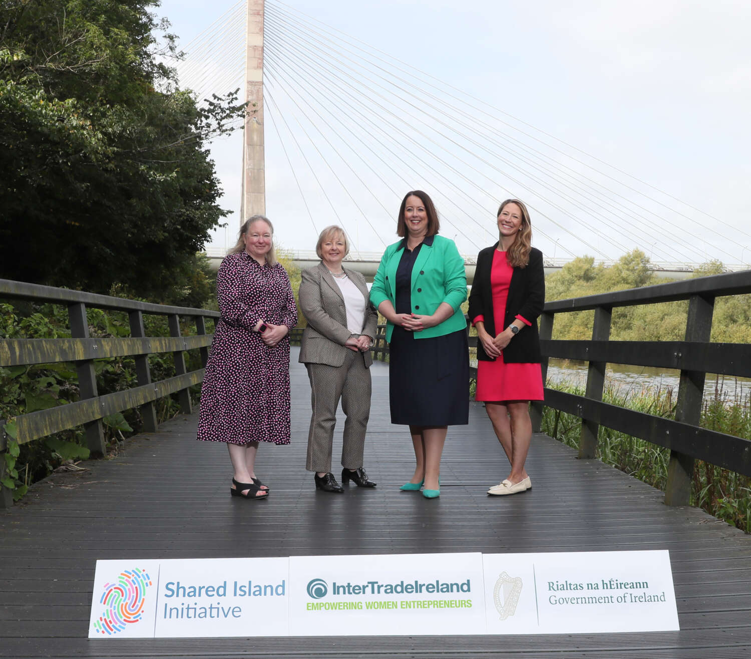 Four women standing in front of the Mary Mc Aleese Boyne Valley Bridge