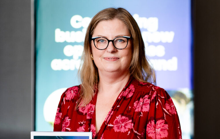 Strategy Assistant Director holding the All-Island Business Monitor report