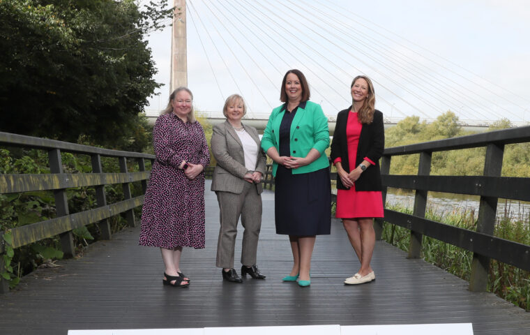 Four women standing in front of the Mary Mc Aleese Boyne Valley Bridge